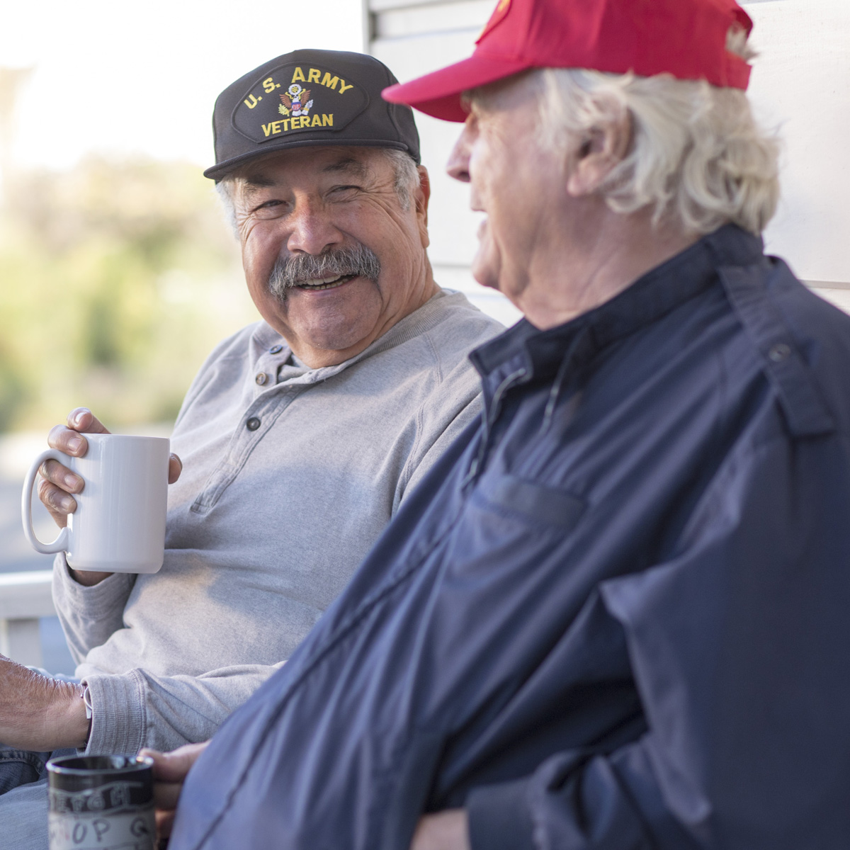 Two men with coffee mugs