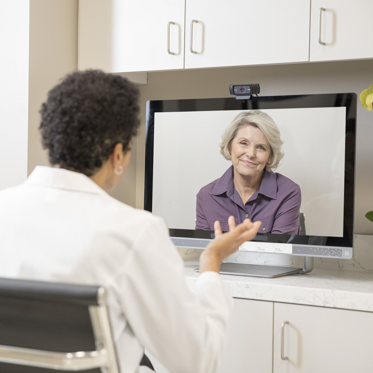 Physician providing healthcare to a patient through telehealth video session