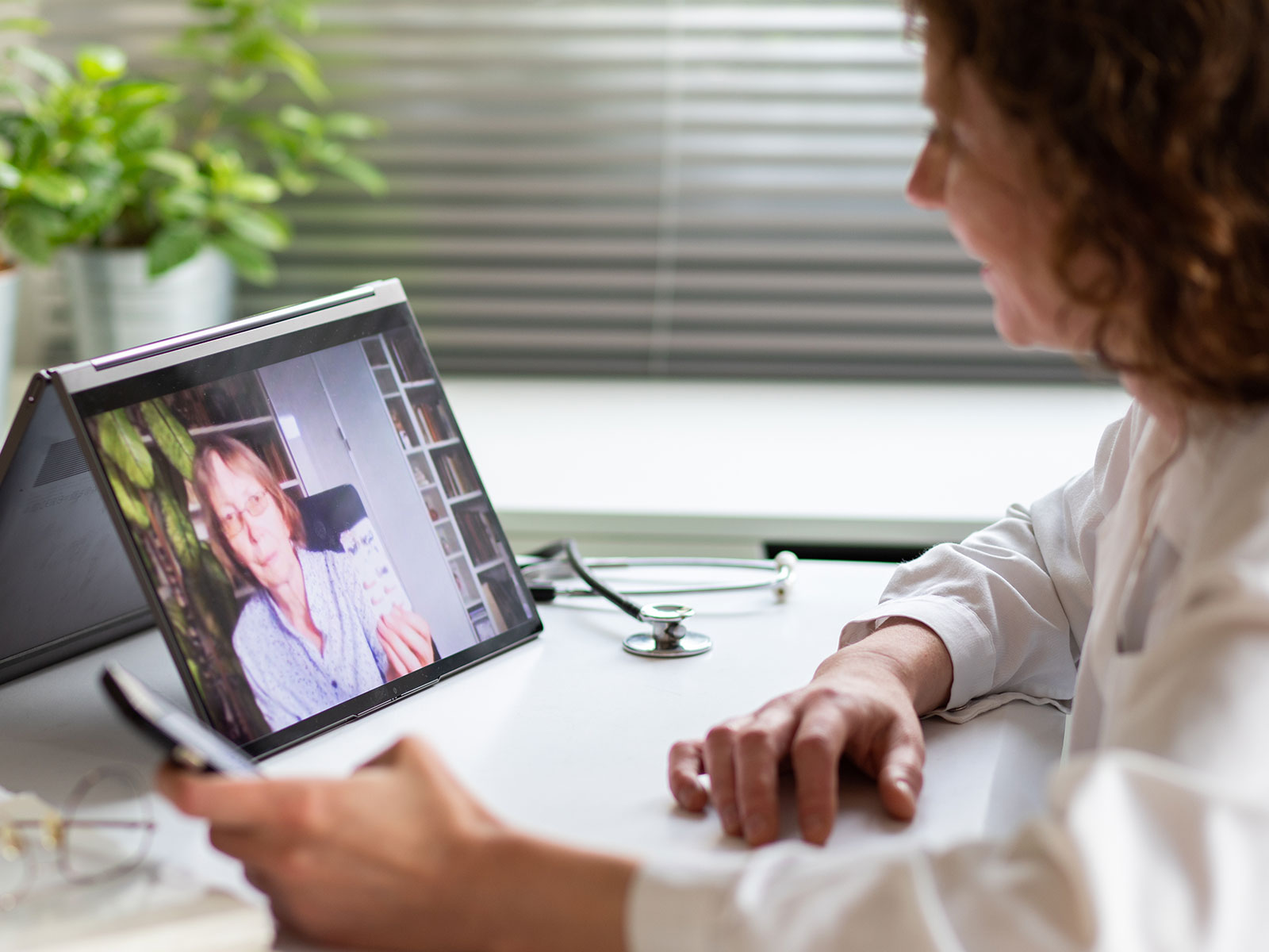 Doctor chats with patient during telehealth appointment.