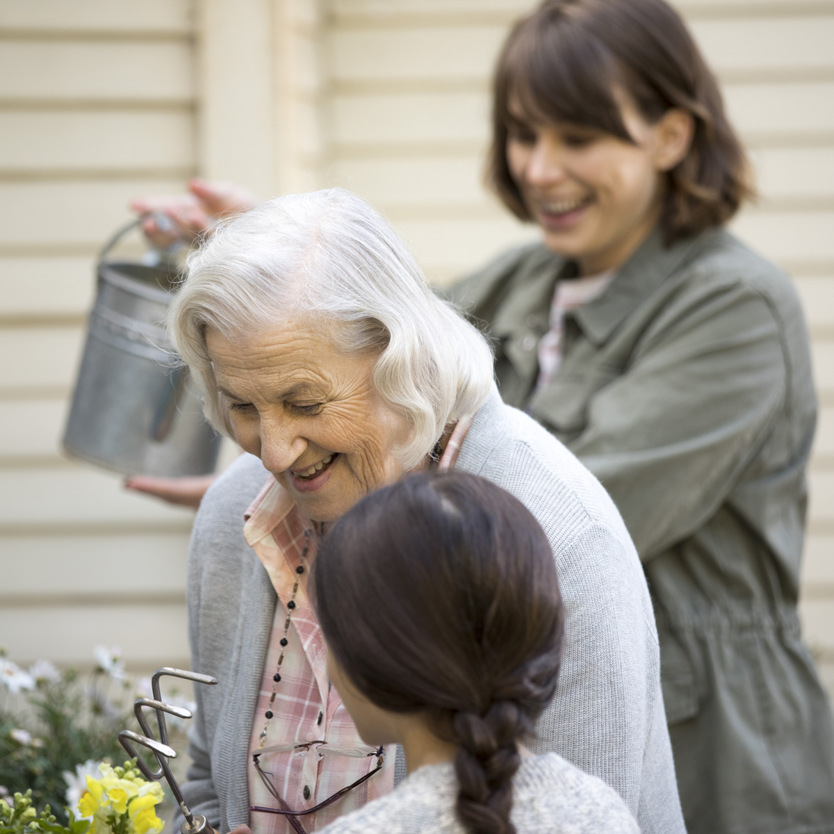 A caregiver helps a loved one garden.