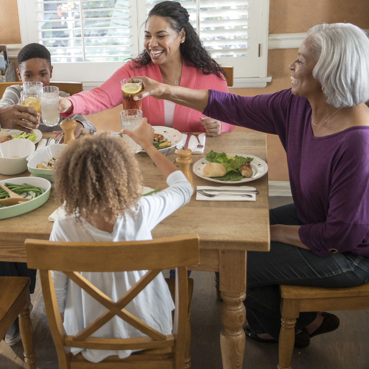 A family gathers around a table for dinner.