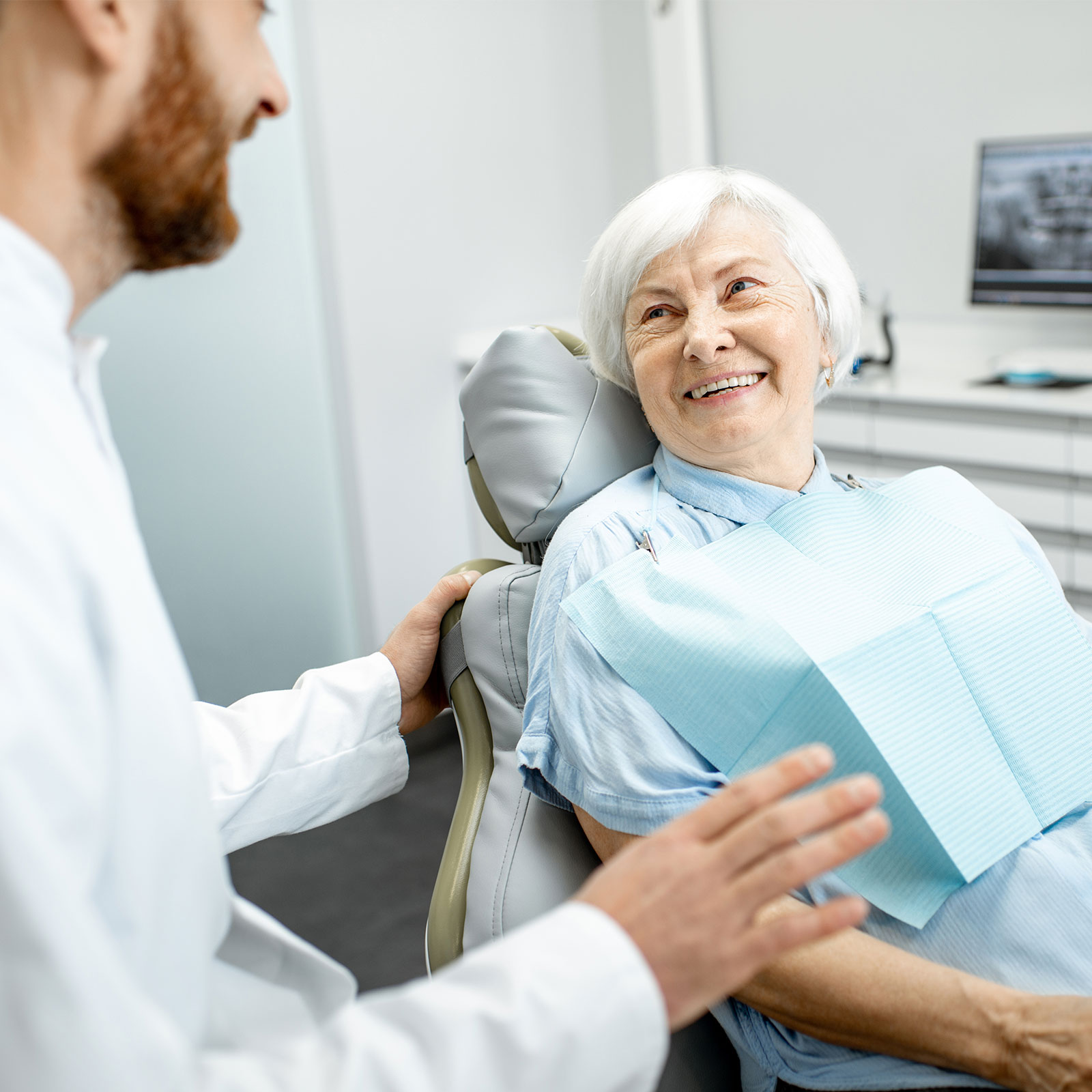 An older woman gets a dental exam.