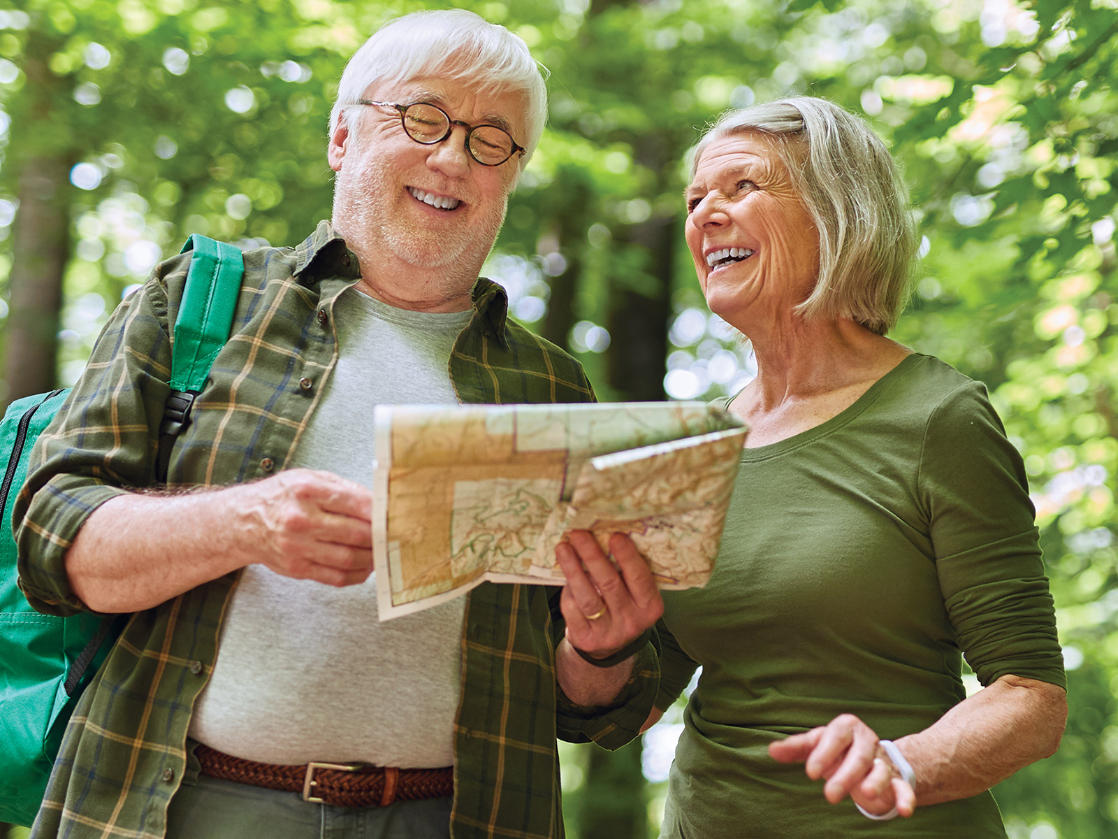 A couple laughs while looking at a map.