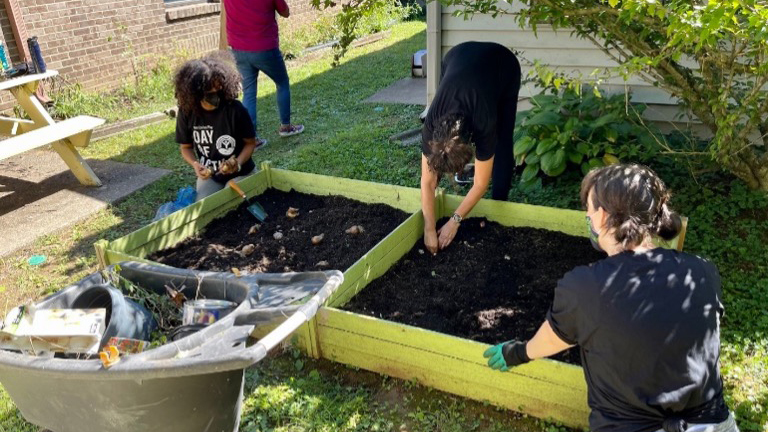 Humana volunteers plant a garden.