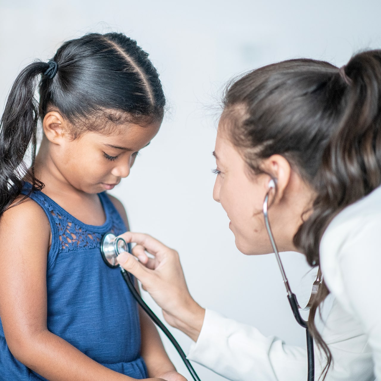 Young girl gets a checkup from the doctor