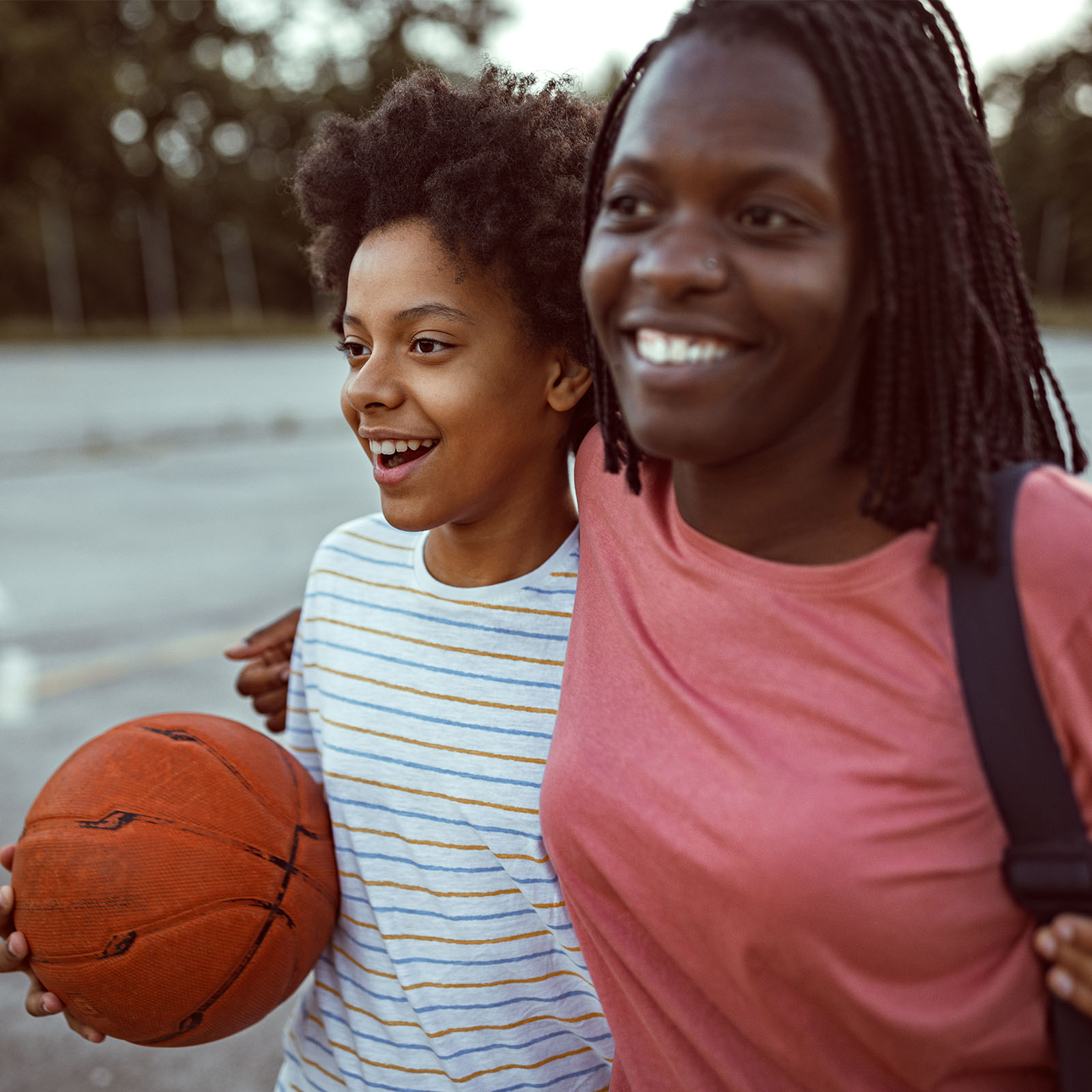 Two girls play basketball