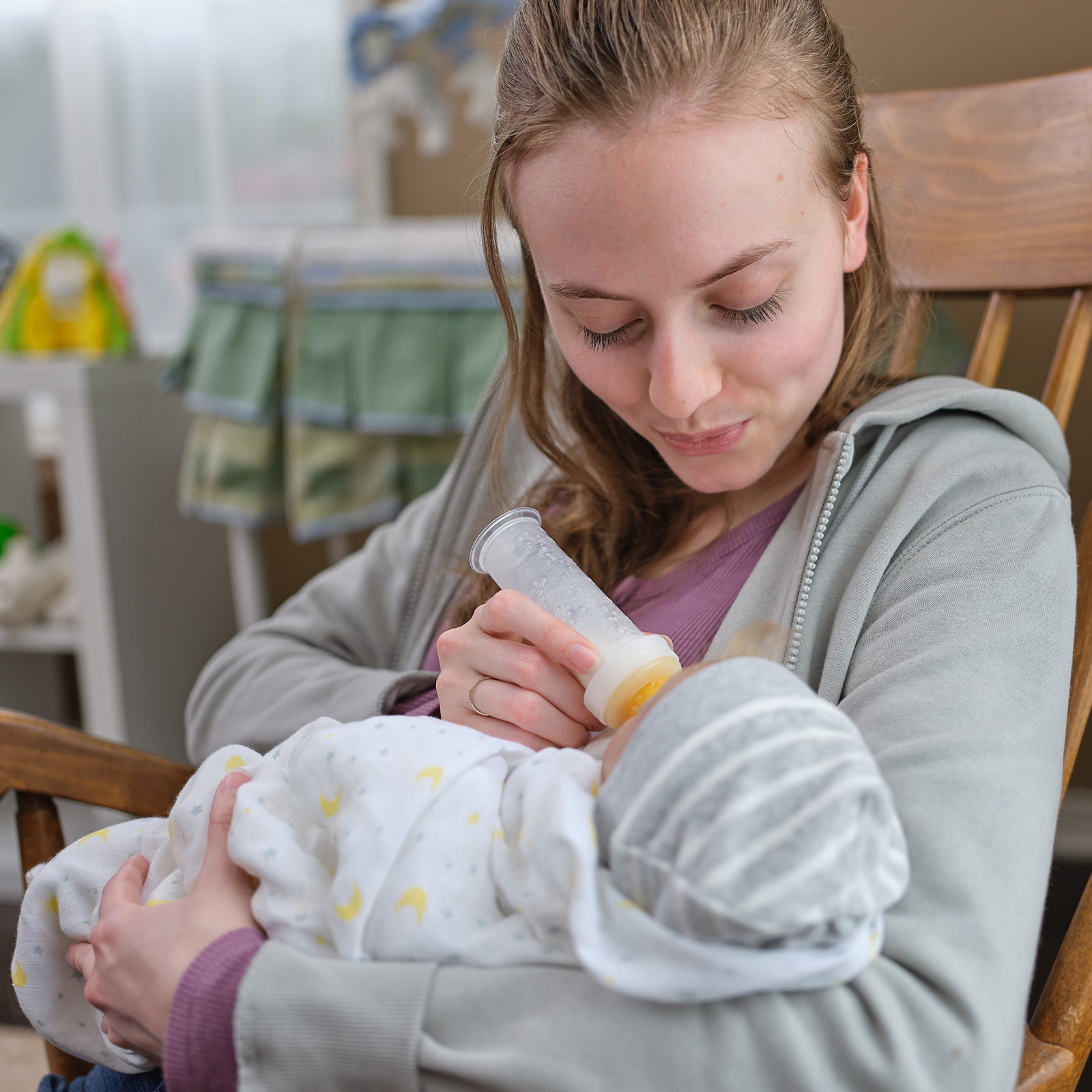 Medicaid member and new mom feeds her baby by bottle
