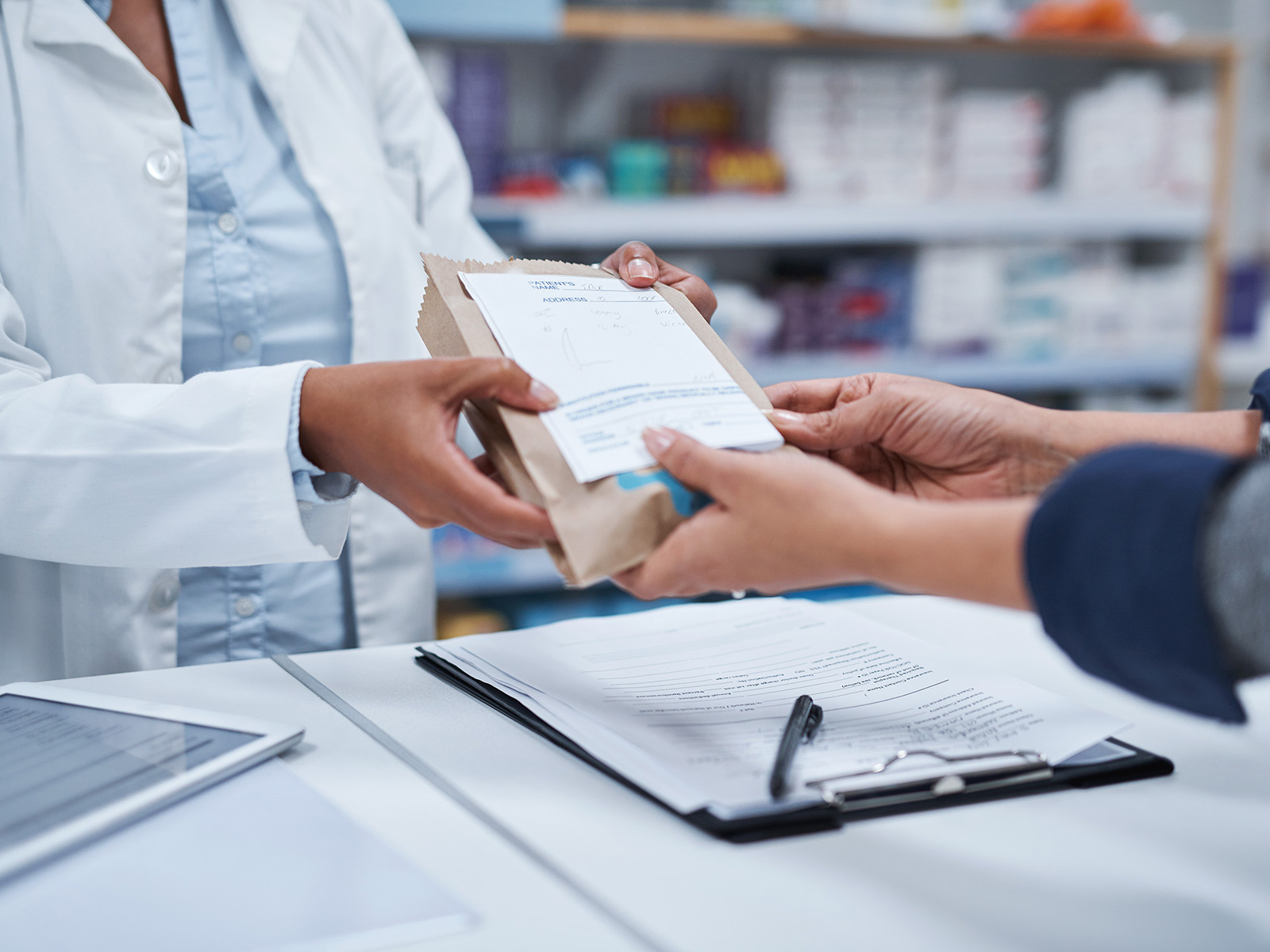 Medicaid member picks up prescription at pharmacy