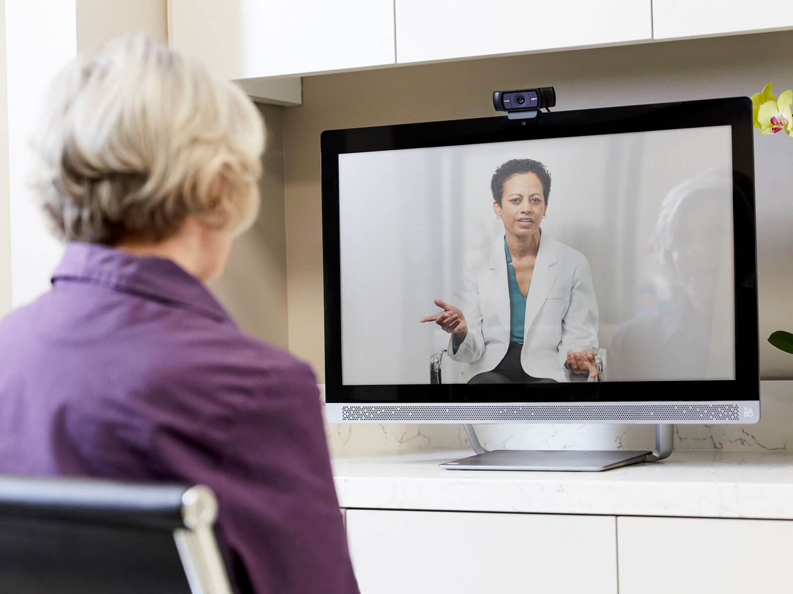 A woman has a video-conference appointment with a doctor using Humana’s telemedicine service.