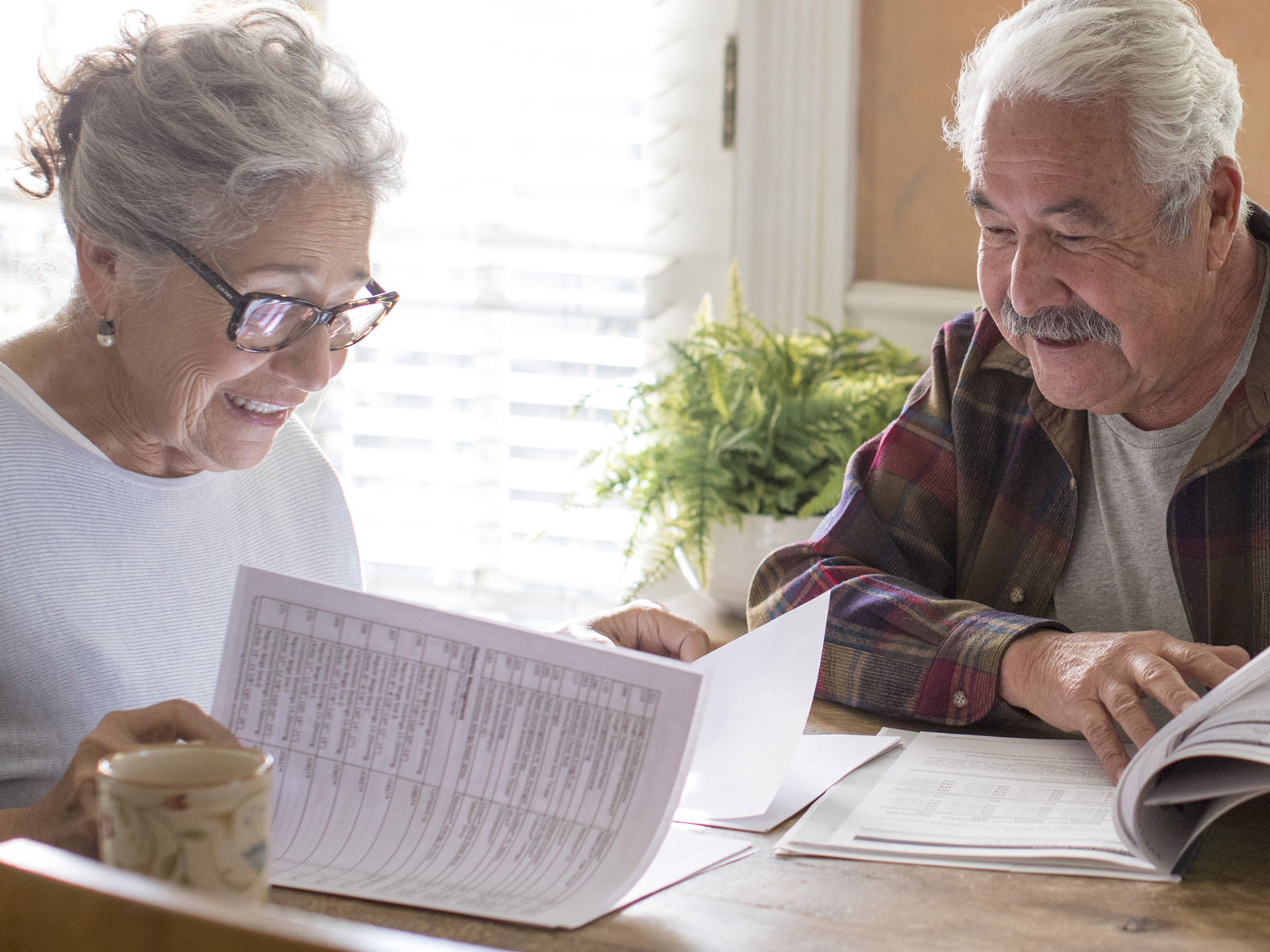 couple reviews Medicare info at the kitchen table